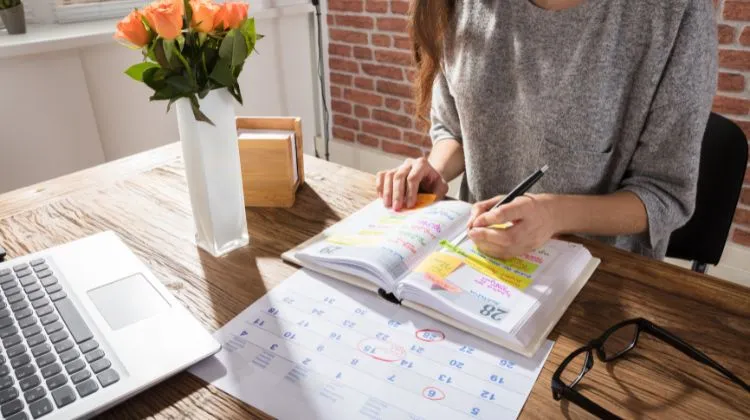 woman adding information to her calendar