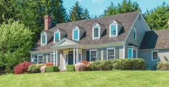 two story home with green lawn